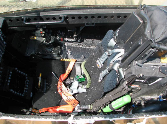 Debris littered the cockpit of F-22 Raptor 03-041 after maintence personnel were forced to cut the canopy to free the trapped pilot.